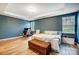Spacious bedroom featuring modern furnishings, hardwood floors, and ample natural light for a cozy ambiance at 1150 Hearth Sw Ln, Concord, NC 28025