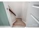 Carpeted staircase leading to the upper level, featuring a handrail and white trim at 1150 Hearth Sw Ln, Concord, NC 28025