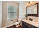 Stylish powder room with wood paneling, modern lighting, and a decorative mirror at 117 Fellspoint Rd, Mooresville, NC 28115