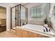 Modern bathroom featuring a soaking tub, separate glass shower, and tile surround at 117 Fellspoint Rd, Mooresville, NC 28115