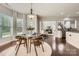 Bright dining room features large windows, a modern chandelier, and elegant hardwood floors at 117 Fellspoint Rd, Mooresville, NC 28115