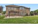 Brick home with a patio, pergola, and well-maintained lawn at 117 Fellspoint Rd, Mooresville, NC 28115