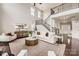 Open-concept living room with a grand staircase, modern furnishings, and abundant natural light at 117 Fellspoint Rd, Mooresville, NC 28115
