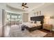 Spacious main bedroom with tray ceiling, natural light, and hardwood floors at 117 Fellspoint Rd, Mooresville, NC 28115