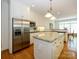 Kitchen with a large stainless steel refrigerator, granite countertops, and hardwood floors at 1209 S South St, Gastonia, NC 28052
