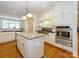 Kitchen with stainless steel refrigerator, granite counters, hardwood floors and white cabinetry at 1209 S South St, Gastonia, NC 28052