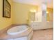 Main bath boasts a relaxing soaking tub and tile surround at 1209 S South St, Gastonia, NC 28052