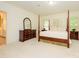 Spacious main bedroom with four poster bed, dresser and carpeted flooring at 1209 S South St, Gastonia, NC 28052