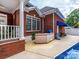 View of the swimming pool featuring an outdoor grill, brick exterior, and partially covered patio at 1209 S South St, Gastonia, NC 28052