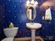 Charming powder room with bold wallpaper, pedestal sink, and gold accents at 1209 S South St, Gastonia, NC 28052