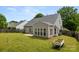 Spacious backyard with a sunroom, patio, and well-maintained lawn, perfect for entertaining at 124 Shephard Hill Dr, Mooresville, NC 28115