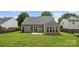 Private backyard featuring the sunroom, attached patio and well maintained lawn at 124 Shephard Hill Dr, Mooresville, NC 28115