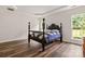 Bright bedroom featuring a traditional bed, hardwood floors, and a tray ceiling at 124 Shephard Hill Dr, Mooresville, NC 28115