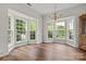 Bright and airy dining room with bay windows, hardwood floors, and elegant chandelier at 124 Shephard Hill Dr, Mooresville, NC 28115