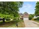 Inviting two-story brick home with mature trees, a well-manicured lawn, and a two-car garage at 124 Shephard Hill Dr, Mooresville, NC 28115