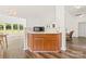 Kitchen area with wooden cabinets, modern microwave and wood flooring at 124 Shephard Hill Dr, Mooresville, NC 28115