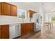 Well-lit kitchen with stainless steel appliances, wooden cabinets, and a bright dining area at 124 Shephard Hill Dr, Mooresville, NC 28115
