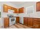 Cozy kitchen featuring wood cabinets, stainless steel appliances, and a bright window view at 124 Shephard Hill Dr, Mooresville, NC 28115