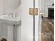 Stylish powder room features a pedestal sink, modern fixtures, and easy access to a guest bath at 124 Shephard Hill Dr, Mooresville, NC 28115