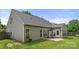 Rear of the home featuring sunroom, attached patio and lush green lawn in the private backyard at 124 Shephard Hill Dr, Mooresville, NC 28115