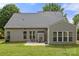 Private backyard featuring the sunroom, attached patio and well maintained lawn at 124 Shephard Hill Dr, Mooresville, NC 28115