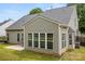Back of home featuring the sunroom, attached patio and private backyard with well maintained lawn at 124 Shephard Hill Dr, Mooresville, NC 28115