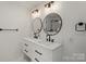Modern bathroom boasting double sinks, granite counters and round mirrors at 135 Mcshag Dr, Kannapolis, NC 28081