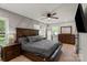 A bright bedroom with wooden furniture, laminate wood flooring, and gray color scheme at 135 Mcshag Dr, Kannapolis, NC 28081