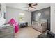 Cozy Bedroom featuring gray wood-look floors, natural lighting, and a gray accent wall at 135 Mcshag Dr, Kannapolis, NC 28081