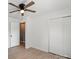 Bright bedroom with a ceiling fan, laminate wood flooring, and a closet at 135 Mcshag Dr, Kannapolis, NC 28081