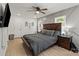 A large bedroom with wooden furniture, laminate wood flooring, and gray color scheme at 135 Mcshag Dr, Kannapolis, NC 28081