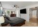 Cozy bedroom featuring a ceiling fan, large TV, and ensuite bath access at 135 Mcshag Dr, Kannapolis, NC 28081