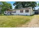 White home with brown shutters and a detached garage at 135 Mcshag Dr, Kannapolis, NC 28081