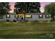 Charming ranch home featuring a covered front porch and spacious front yard at 135 Mcshag Dr, Kannapolis, NC 28081