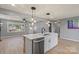 Updated kitchen with an island featuring pendant lights, stainless steel appliances, and bright white cabinets at 135 Mcshag Dr, Kannapolis, NC 28081