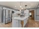 Bright kitchen features stainless steel appliances, white cabinets and a center island at 135 Mcshag Dr, Kannapolis, NC 28081