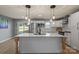 Beautifully renovated kitchen with a large island, modern lighting, and stainless steel appliances at 135 Mcshag Dr, Kannapolis, NC 28081