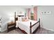 This bedroom has neutral decor, a wooden bedframe and a matching side table at 136 Meadow View Dr, Statesville, NC 28677