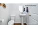 Modern half bathroom featuring a pedestal sink, wood floors, and contemporary fixtures at 138 Meadow View Dr, Statesville, NC 28677