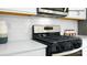 Close-up of a modern gas range and oven, highlighting the white subway tile backsplash and sleek countertops at 138 Meadow View Dr, Statesville, NC 28677