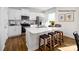 Bright kitchen featuring white cabinets, stainless steel appliances, and a center island with bar seating at 138 Meadow View Dr, Statesville, NC 28677