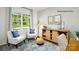 Comfortable sitting area boasts natural light, stylish decor, and wood-look floors perfect for entertaining at 138 Meadow View Dr, Statesville, NC 28677