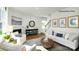 Bright living room featuring a fireplace, hardwood floors, and comfortable seating area at 138 Meadow View Dr, Statesville, NC 28677