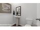 Stylish half-bathroom with pedestal sink, framed mirror, and modern fixtures that optimizes space at 140 Meadow View Dr, Statesville, NC 28677