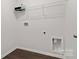 A clean laundry room with new flooring, new hook-ups, and wire shelving for storage at 140 Meadow View Dr, Statesville, NC 28677
