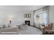 Cozy living room with a fireplace, plush seating, and natural light, perfect for relaxation and entertaining at 140 Meadow View Dr, Statesville, NC 28677