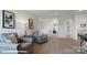 Inviting upstairs loft area with comfortable seating, neutral decor, and access to bedrooms at 140 Meadow View Dr, Statesville, NC 28677