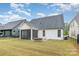 View of the home's backyard featuring a screened in porch and grass at 14119 Shelburne Village Dr, Charlotte, NC 28278