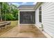 A covered screened porch and patio area, with lush greenery at 14119 Shelburne Village Dr, Charlotte, NC 28278