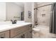 Modern bathroom with gray vanity, white countertop, tile shower, and neutral color palette at 14119 Shelburne Village Dr, Charlotte, NC 28278